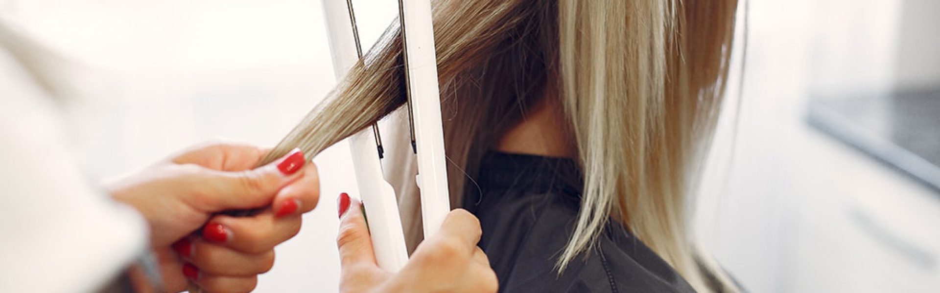 Hairdresser working with hear her client. Woman in a hair salon